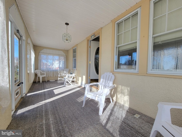 unfurnished sunroom featuring a chandelier
