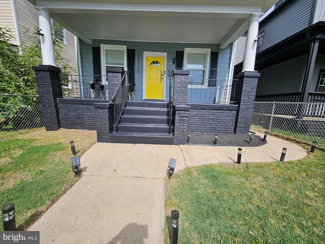 exterior space with a porch, a front yard, and fence