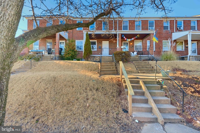 view of front facade featuring covered porch and brick siding