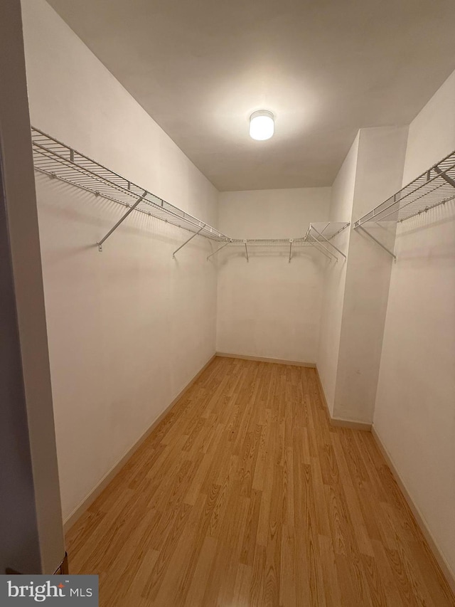 spacious closet with light wood-style floors