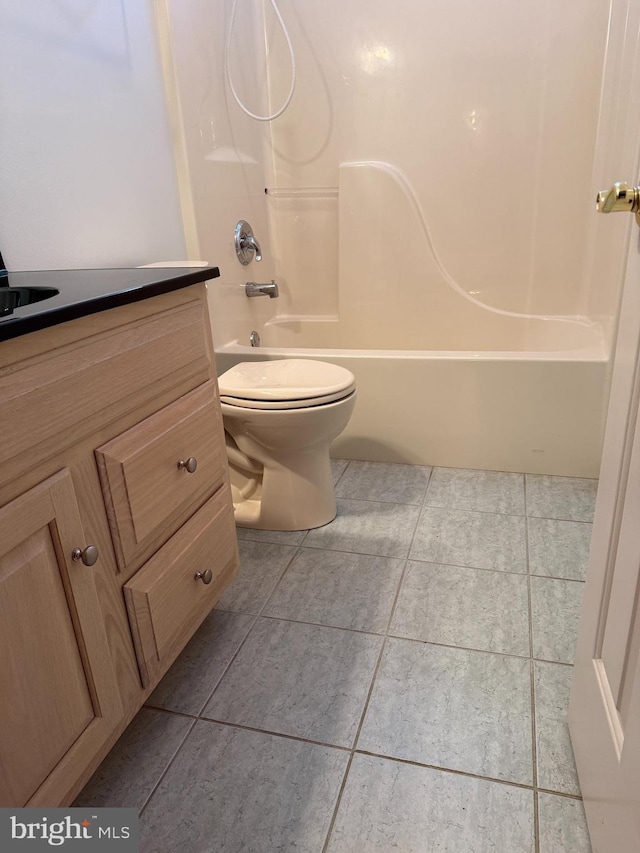 full bathroom with tile patterned flooring, shower / tub combination, and toilet