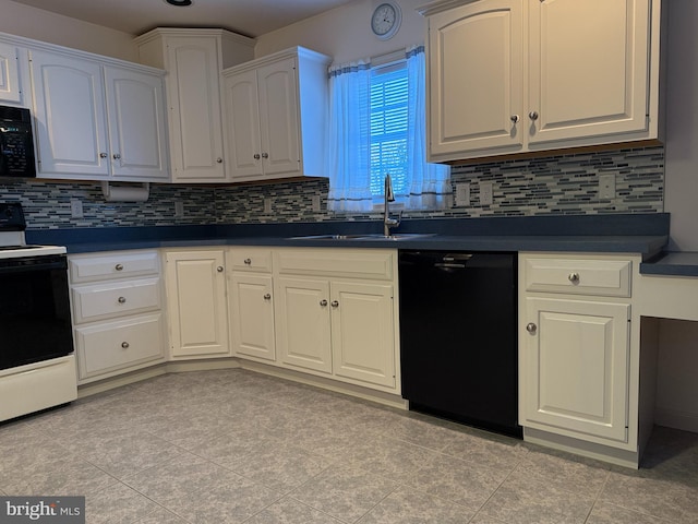 kitchen with dark countertops, backsplash, white cabinetry, a sink, and black appliances