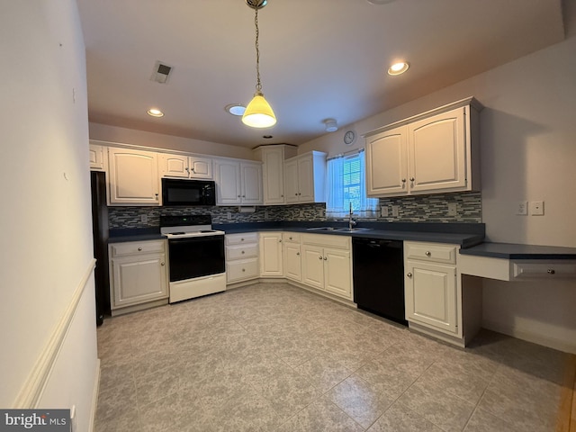 kitchen featuring dark countertops, visible vents, white cabinets, a sink, and black appliances