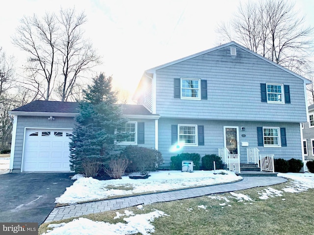 view of front of house with an attached garage and aphalt driveway