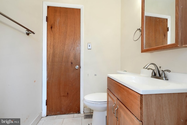 bathroom featuring tile patterned flooring, vanity, and toilet