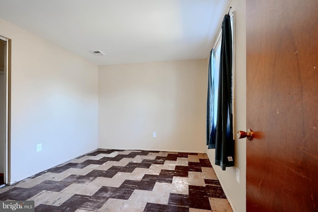 unfurnished bedroom with visible vents and tile patterned floors