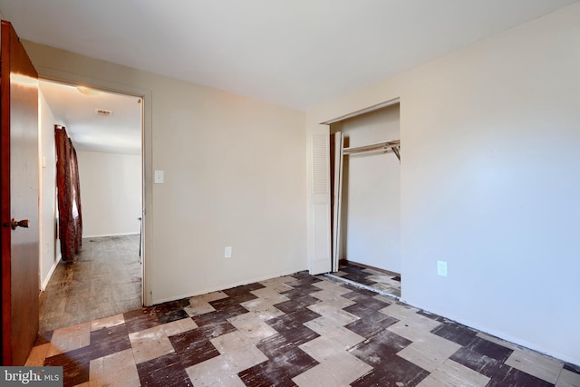 unfurnished bedroom featuring a closet and tile patterned floors