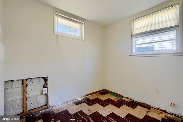 spare room featuring plenty of natural light and tile patterned floors