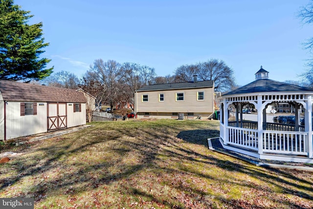 view of yard featuring a storage shed, an outdoor structure, and a gazebo