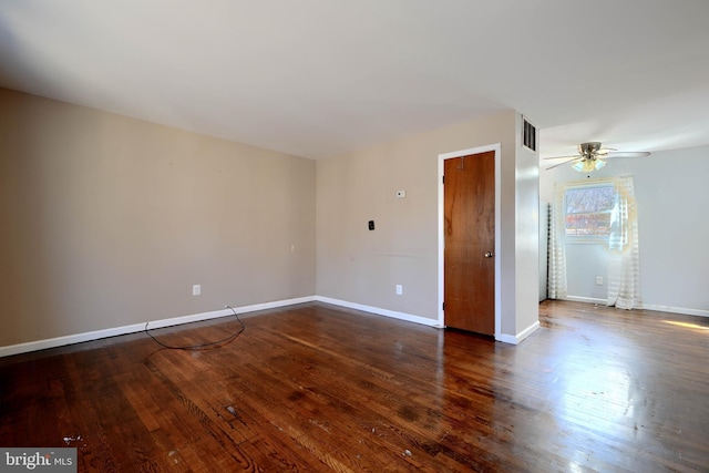 empty room featuring a ceiling fan, wood-type flooring, visible vents, and baseboards