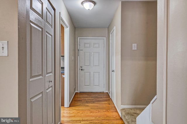 hallway with light wood-style floors and baseboards