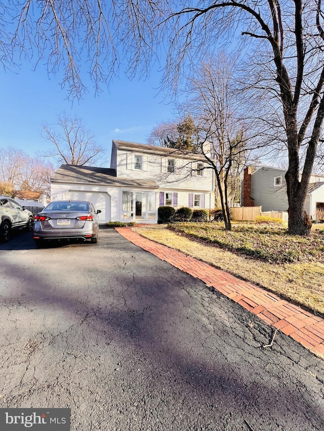 view of front of home with aphalt driveway and an attached garage