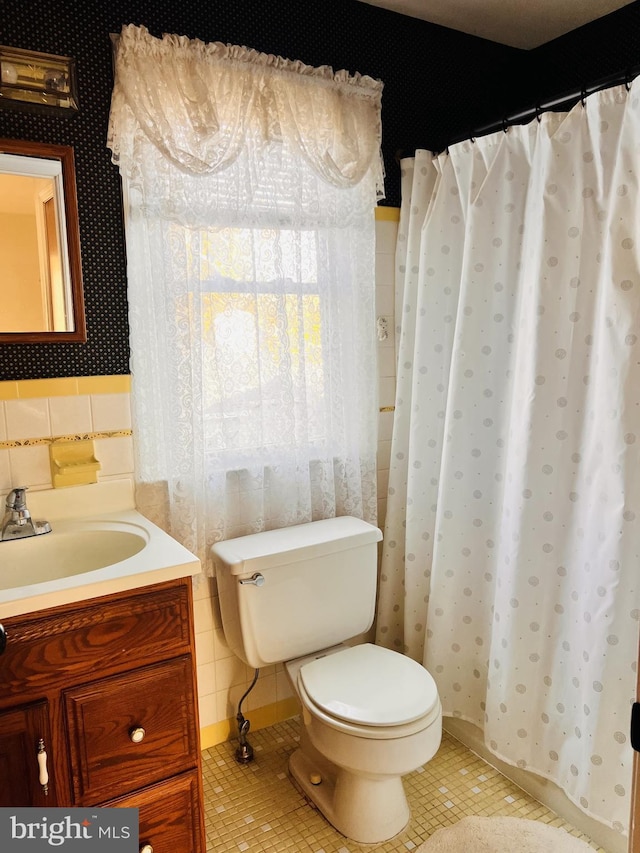 full bath with vanity, toilet, and tile patterned flooring