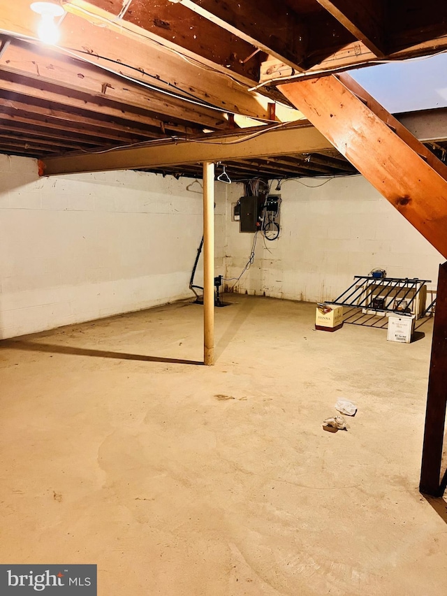 unfinished basement featuring electric panel