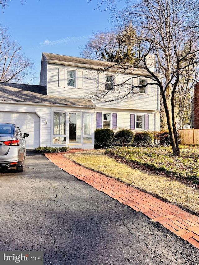 colonial home with driveway and a garage