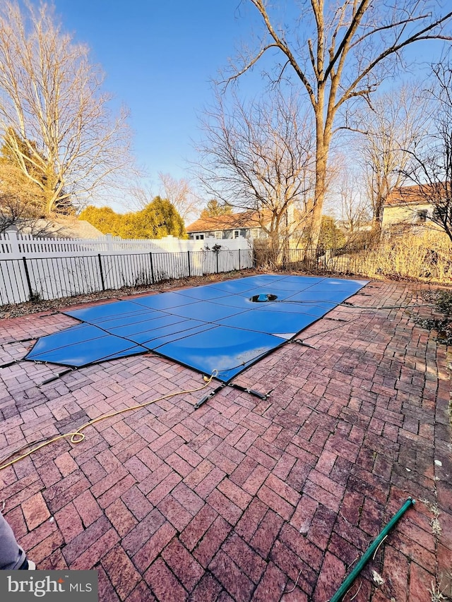 view of swimming pool with a patio area, a fenced in pool, and fence