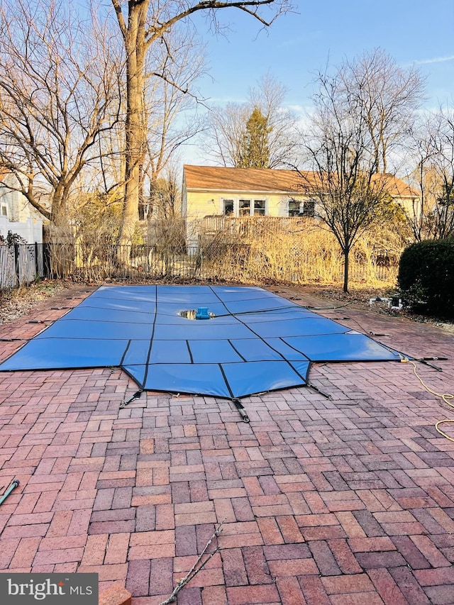 view of pool featuring a patio, fence, and a fenced in pool