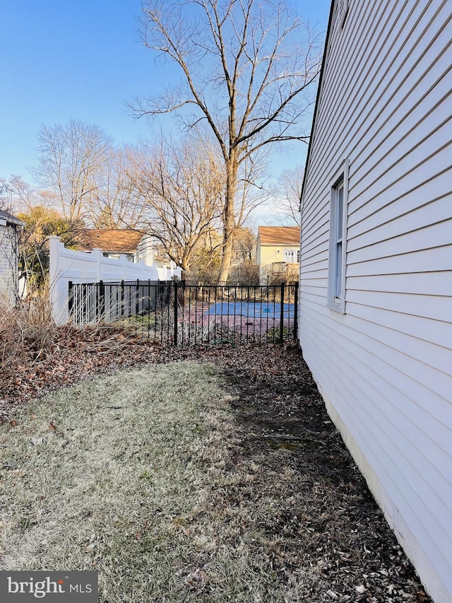 view of yard with a pool and fence