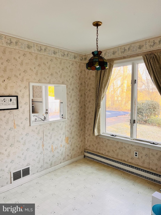 interior space featuring a baseboard heating unit, visible vents, and wallpapered walls