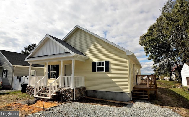 view of front facade featuring crawl space, covered porch, and board and batten siding