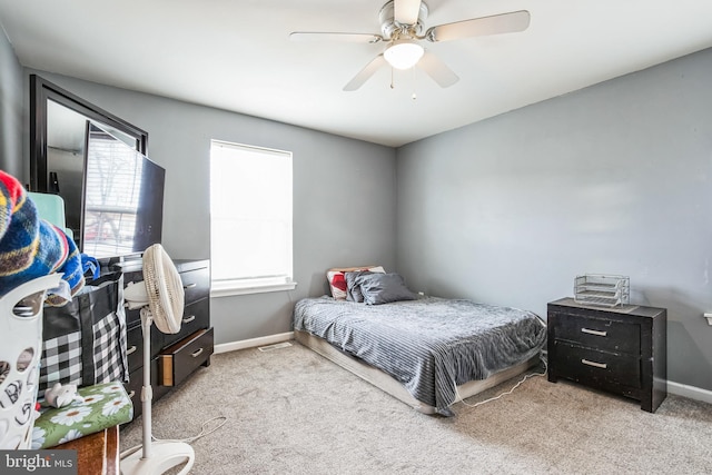 carpeted bedroom with a ceiling fan, visible vents, and baseboards