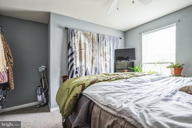 carpeted bedroom featuring a ceiling fan and baseboards