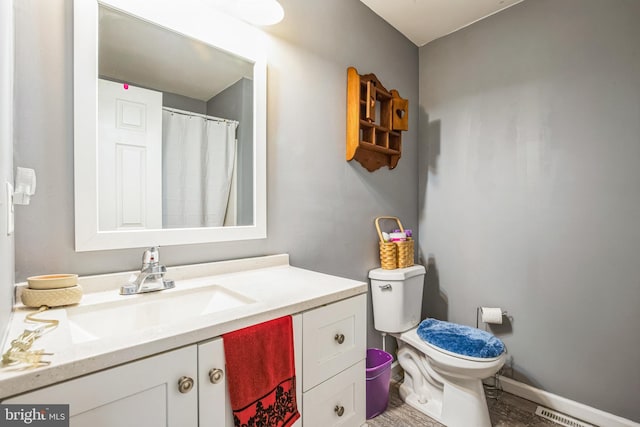 full bathroom with toilet, baseboards, visible vents, and vanity