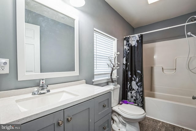 bathroom with shower / bath combination with curtain, vanity, toilet, and wood finished floors