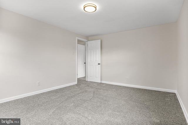 unfurnished room featuring baseboards and carpet flooring