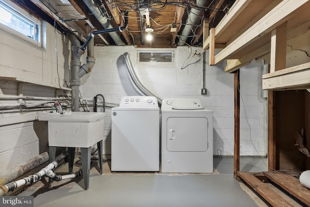 laundry area featuring laundry area, a sink, and washer and clothes dryer