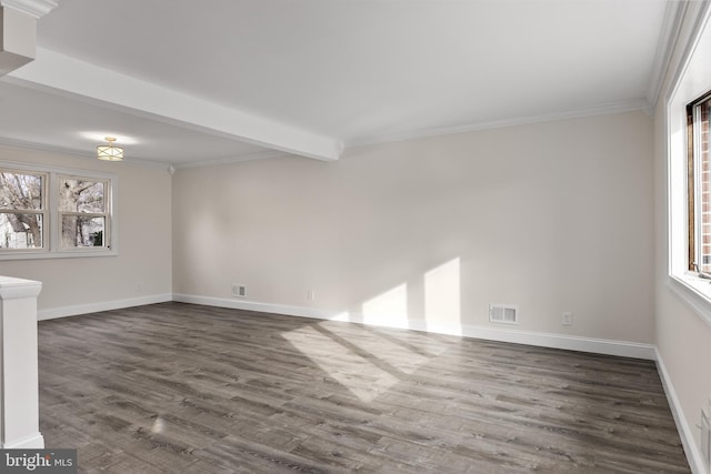 spare room featuring dark wood-style floors, crown molding, visible vents, beamed ceiling, and baseboards