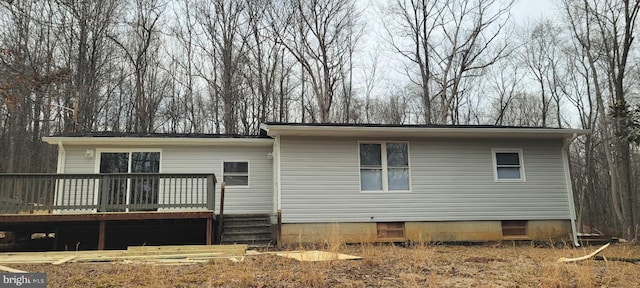 rear view of house featuring a deck