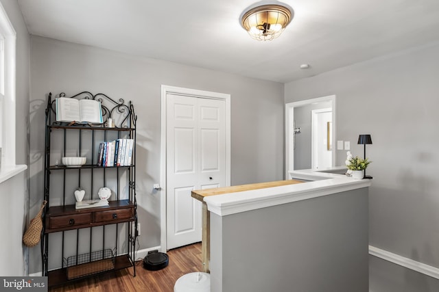 bar with baseboards and wood finished floors