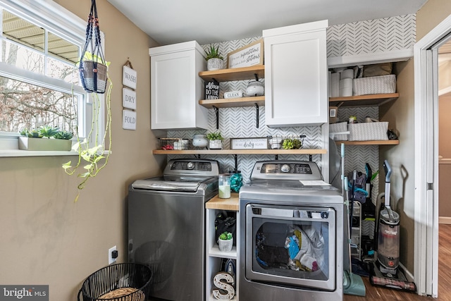 laundry room featuring cabinet space, washer and clothes dryer, and wood finished floors