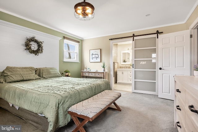 bedroom with crown molding, a barn door, connected bathroom, and light colored carpet