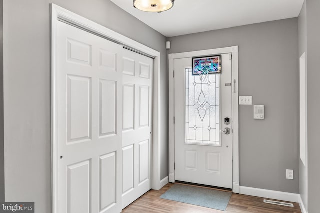 entrance foyer with light wood-style floors and baseboards