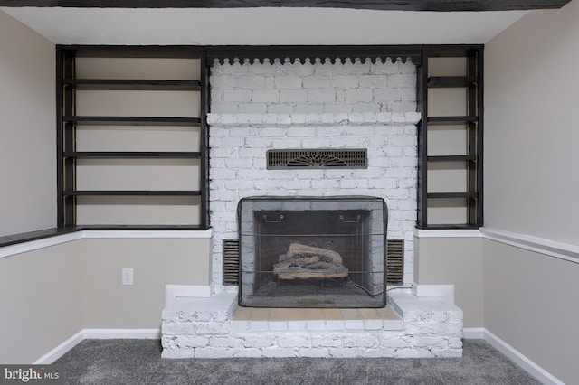 room details with carpet flooring, visible vents, a fireplace, and baseboards