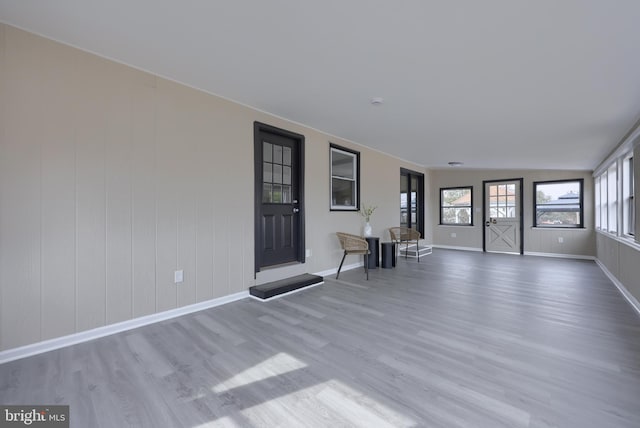 interior space featuring baseboards and wood finished floors