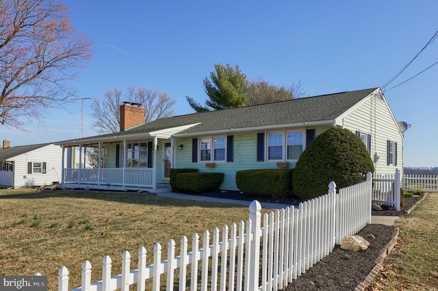 ranch-style house with a front yard, roof with shingles, covered porch, a chimney, and a fenced front yard