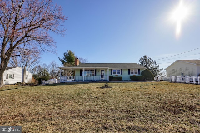 ranch-style home featuring a front yard, covered porch, a chimney, and fence