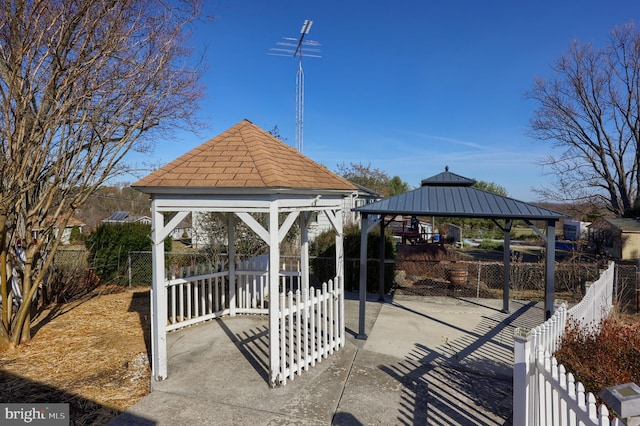 view of home's community with a gazebo and fence