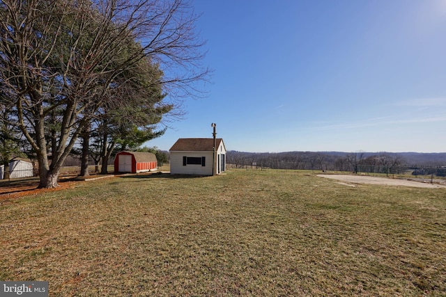 view of yard featuring an outbuilding and a shed