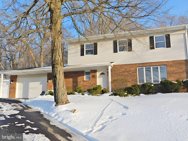 view of front facade with a garage and brick siding