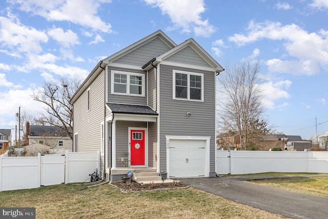 traditional home featuring a garage, a front yard, fence, and aphalt driveway