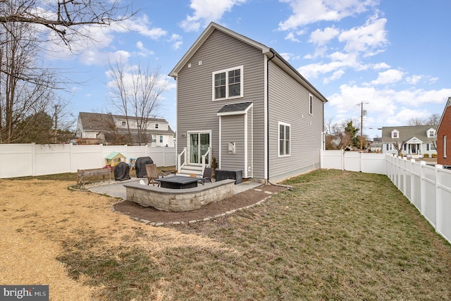 rear view of property with entry steps, a fenced backyard, a lawn, and a patio