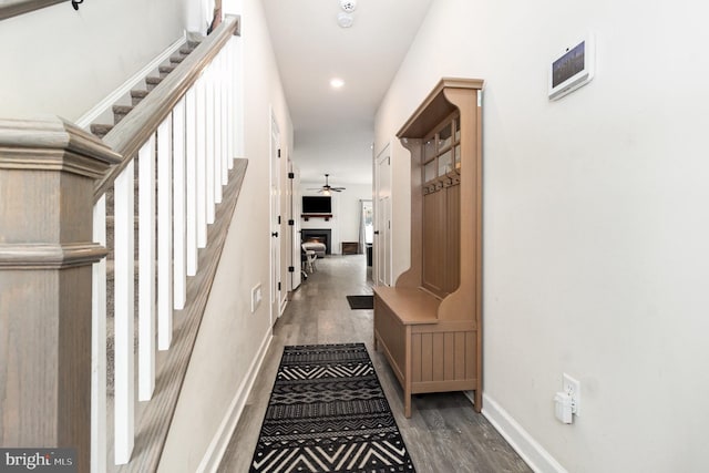 hall featuring stairway, recessed lighting, wood finished floors, and baseboards