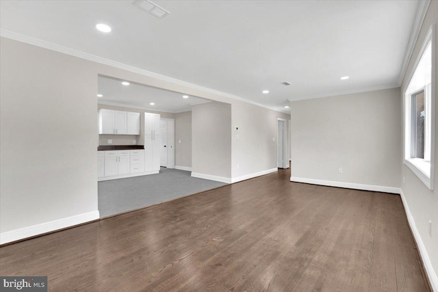 unfurnished living room with ornamental molding, dark wood-type flooring, recessed lighting, and baseboards