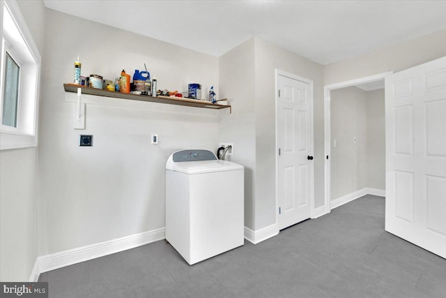 laundry room with laundry area, baseboards, and washer / clothes dryer