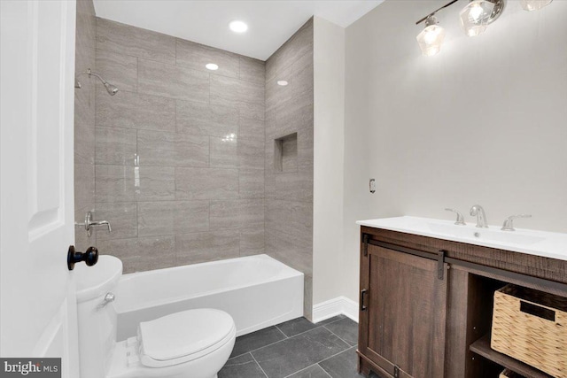 bathroom featuring toilet, vanity,  shower combination, baseboards, and tile patterned floors