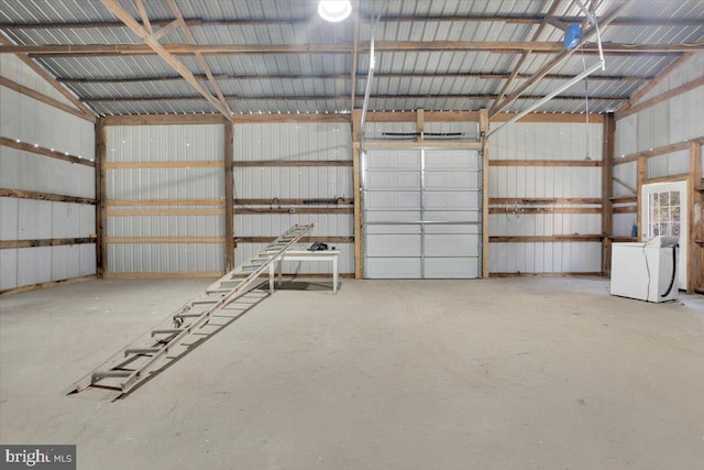 garage featuring washer / dryer and metal wall